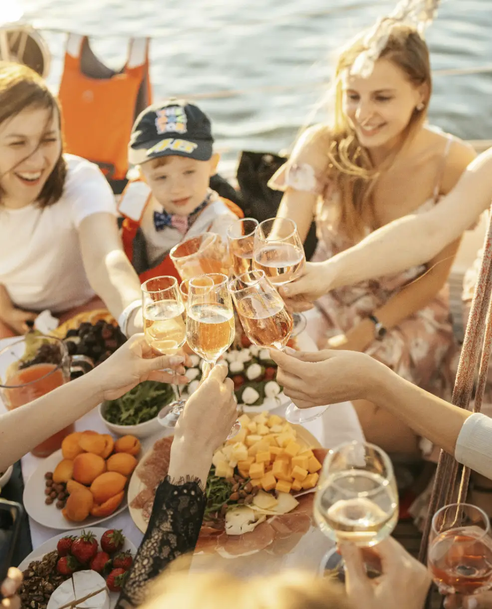 A group of people sitting around a table with food.