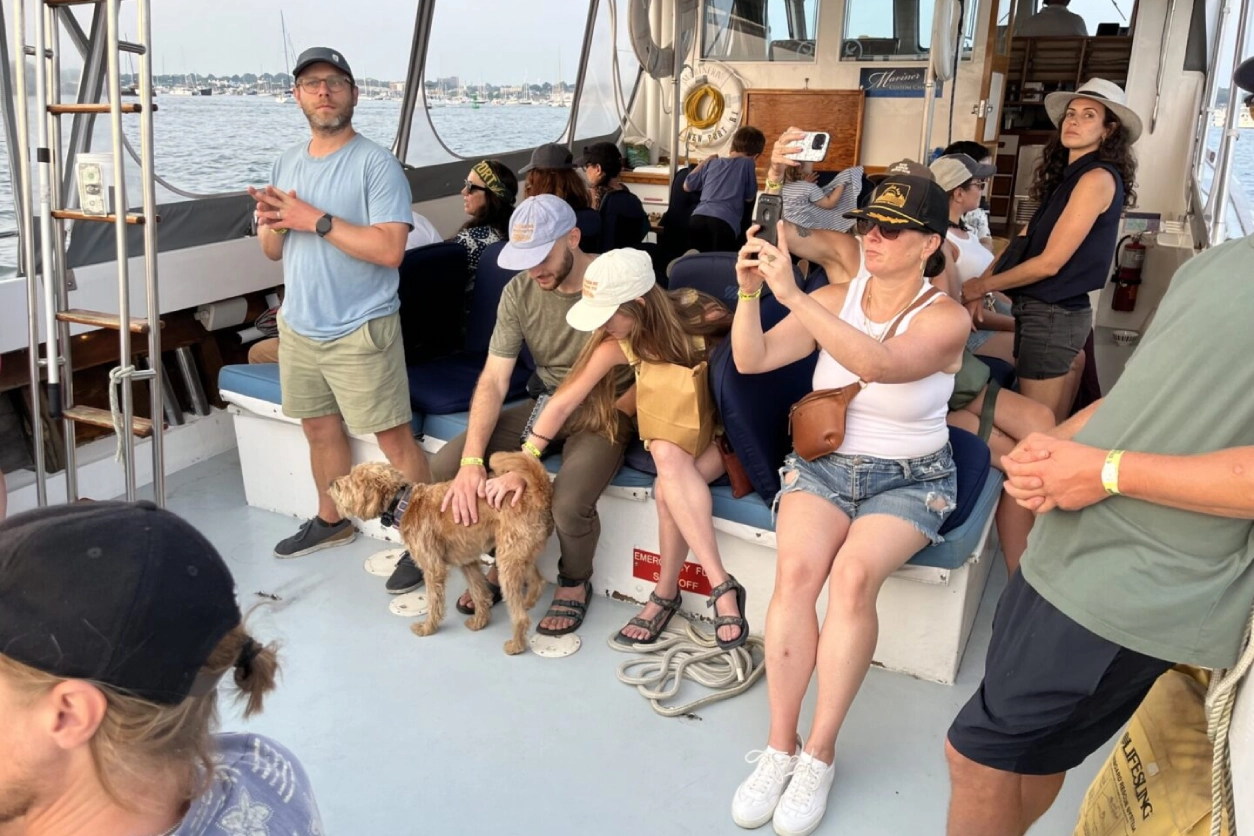 A group of people sitting on the deck of a boat.