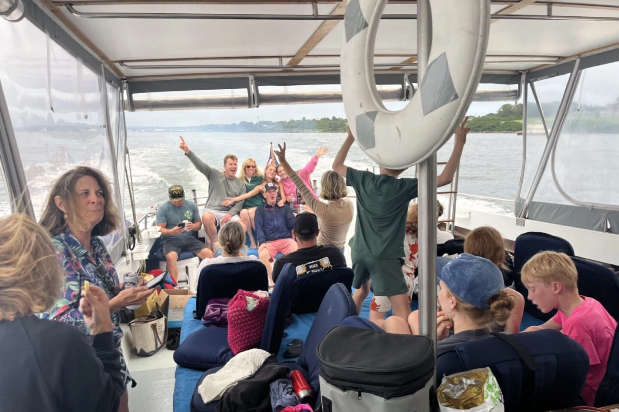 A group of people on a boat in the water.