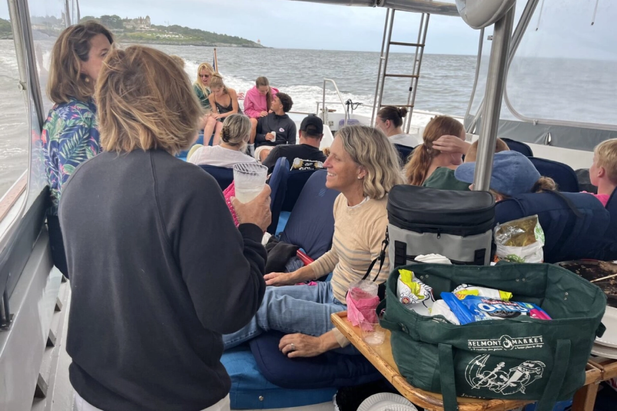 A group of people sitting on the deck of a boat.