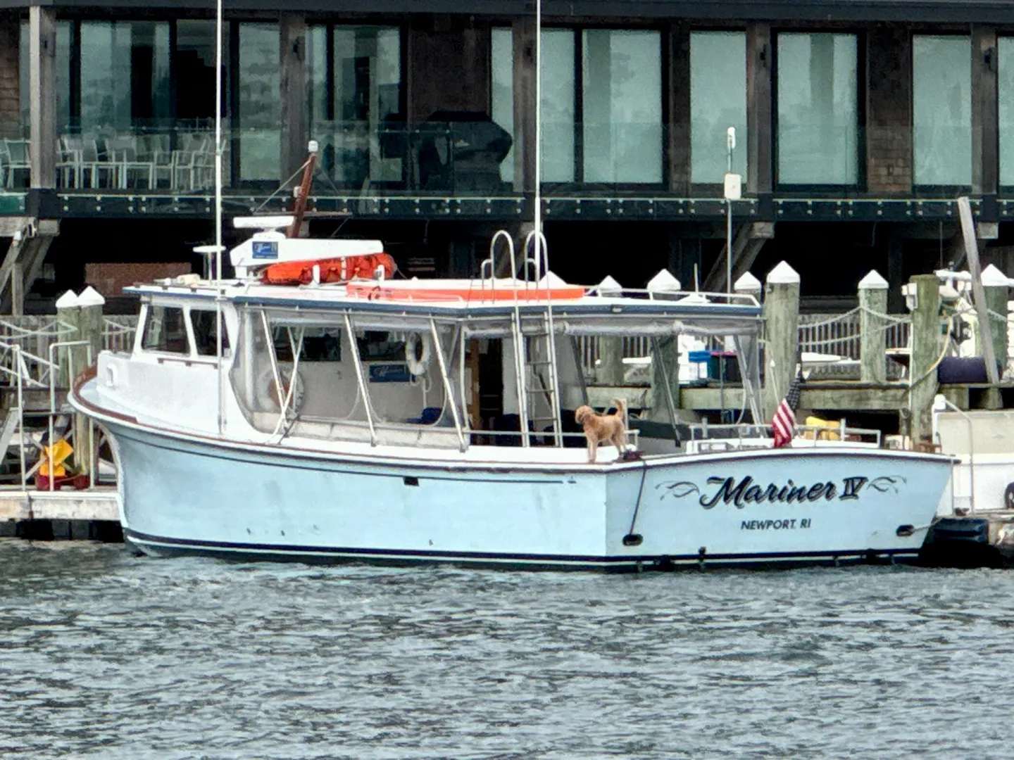 A boat is in the water near some buildings.