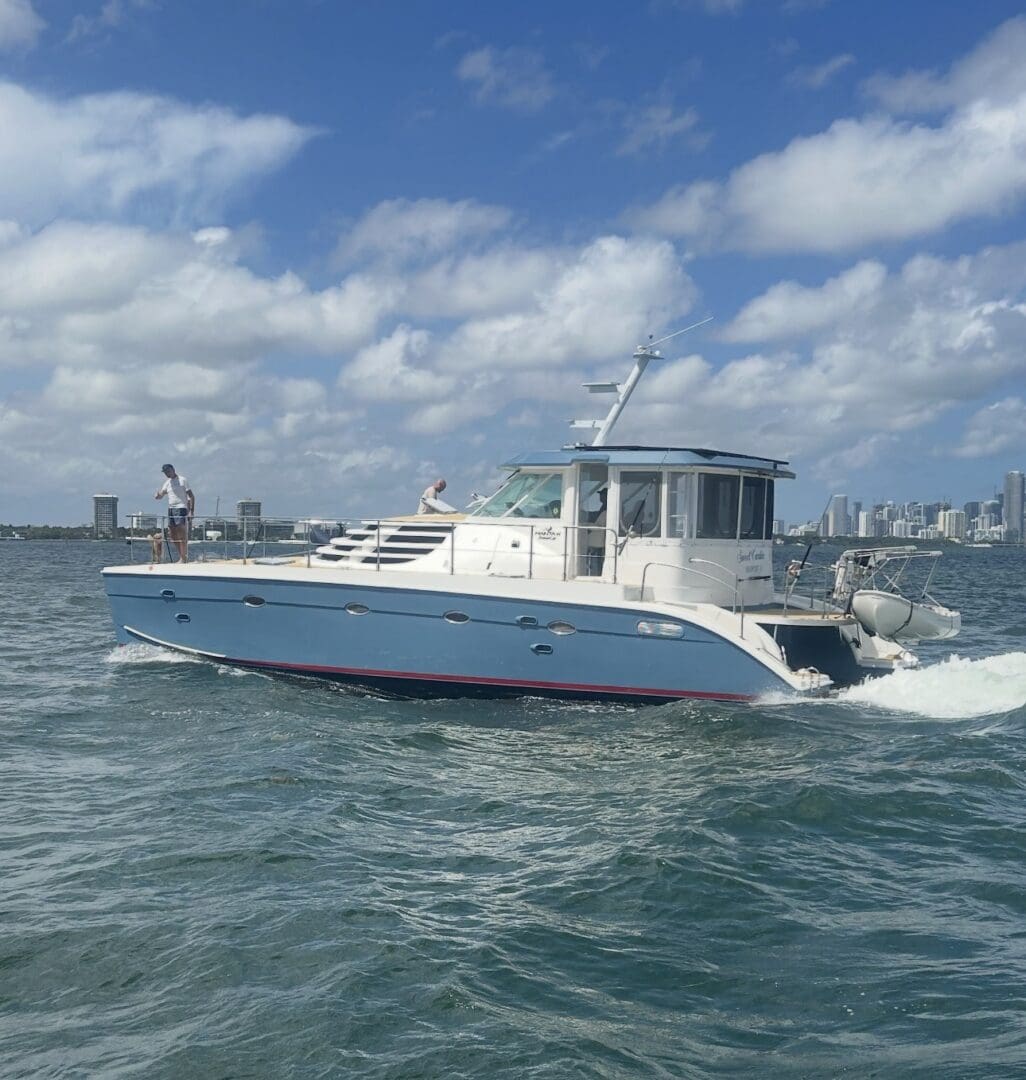 Motor yacht cruising near city skyline